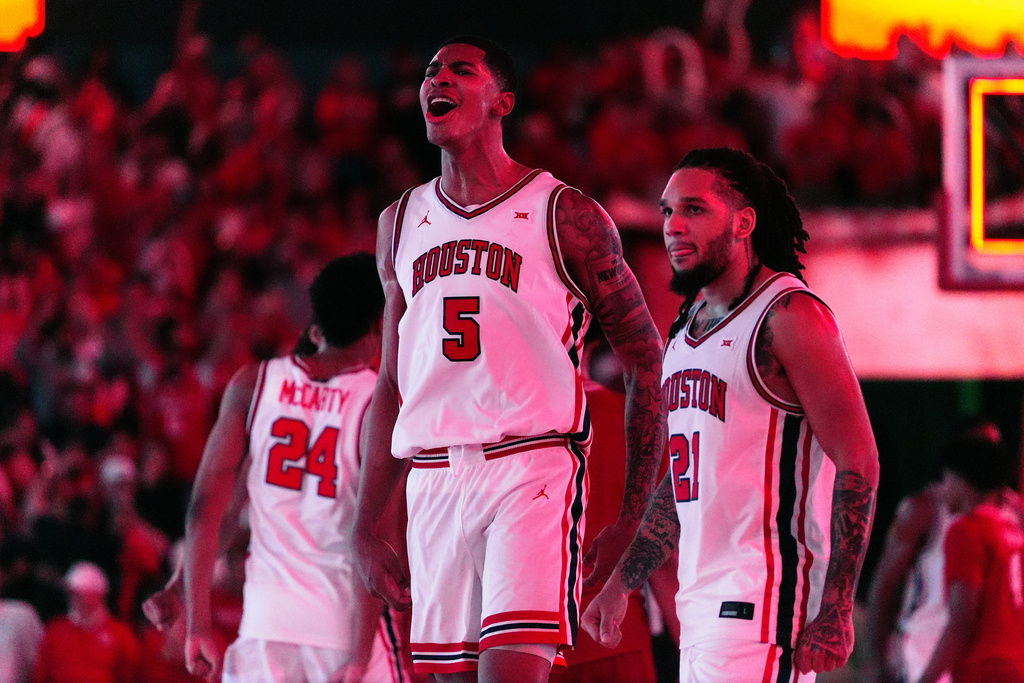 Houston guard Emanuel Sharp (21) and center Chris Cenac Jr. (5) celebrate after winning an NCAA college basketball game against Texas Tech in Houston, Tuesday, Jan. 6, 2026. (AP Photo/Ashley Landis)