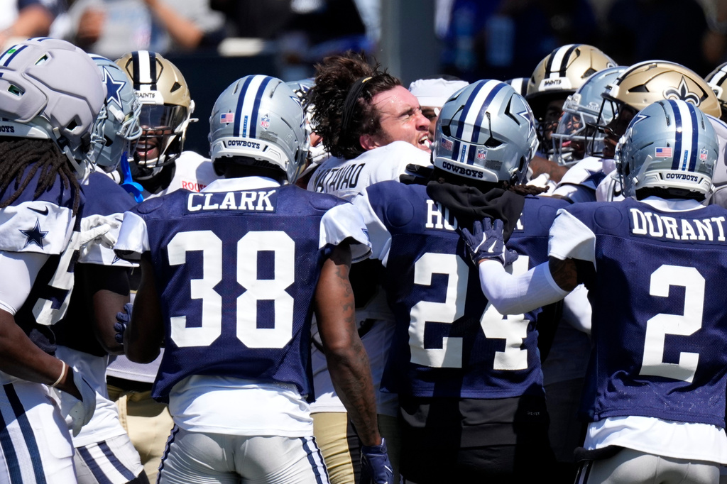 New Orleans Saints tight end Moliki Matavao, center, scuffle with members of the Dallas Cowboys during an NFL football joint practice, Tuesday, Aug. 18, 2026, in Oxnard, Calif. (AP Photo/Mark J. Terrill)