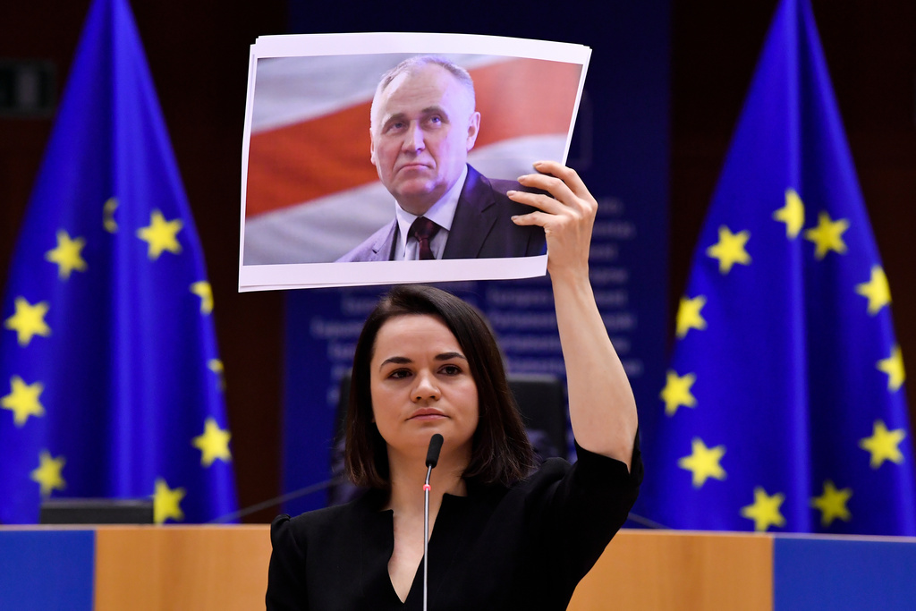 FILE - Belarusian opposition politician Sviatlana Tsikhanouskaya holds a photo of fellow opposition figure Mikalai Statkevich as she speaks at the Sakharov Prize ceremony at the European Parliament in Brussels, Dec. 16, 2020. (John Thys/Pool Photo via AP, File)