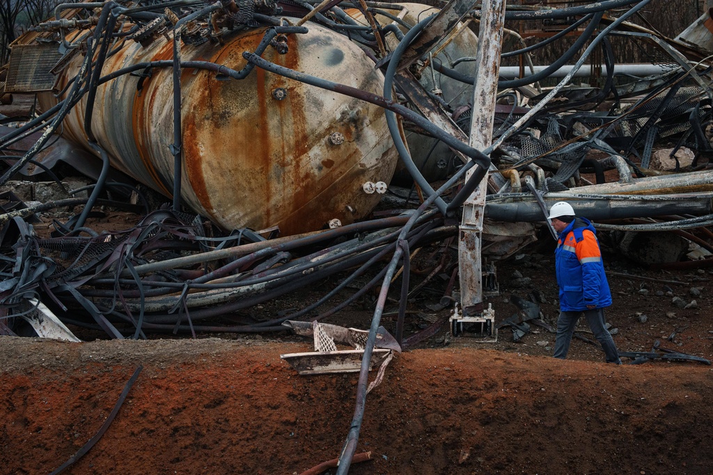 Victor, Naftogaz worker walks in front of a Naftogaz gas extraction facility destroyed by a Russian strike in Ukraine, on Tuesday, Nov. 18, 2025. (AP Photo/Evgeniy Maloletka)