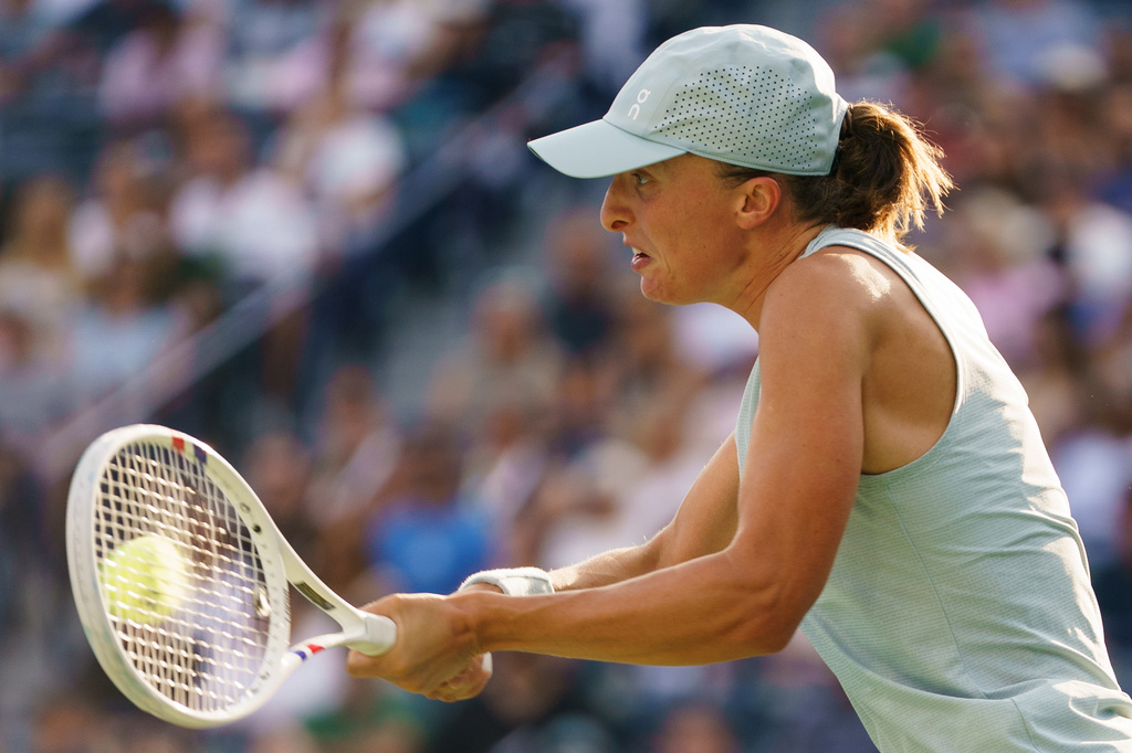 Iga Swiatek, of Poland, returns the ball from Elena Rybakina, of Kazakhstan during a National Bank Open final tennis match, in Toronto, Thursday, Aug. 13, 2026. (Chris Young/The Canadian Press via AP)