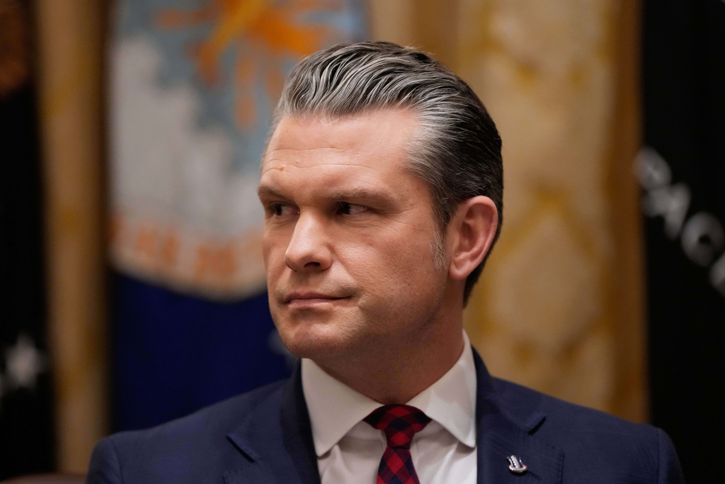 Defense Secretary Pete Hegseth listens as President Donald Trump speaks during a Cabinet meeting at the White House, Tuesday, Dec. 2, 2025, in Washington. (AP Photo/Julia Demaree Nikhinson)