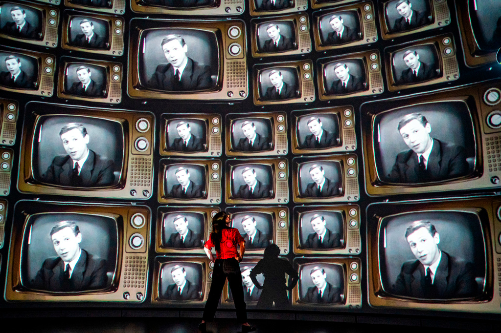 FILE - Head of creative enterprise, Maddie Hall, watches hundreds of television screens with broadcaster and naturalist David Attenborough's face, from when he was a young broadcaster, projected on a 360 degree screen inside the dome within the Market Hall ahead of a public release of an immersive film to mark his 100th birthday on May 8, at Real Ideas in Devonport, Plymouth, England, May 6, 2026. (Ben Birchall/PA via AP, File)