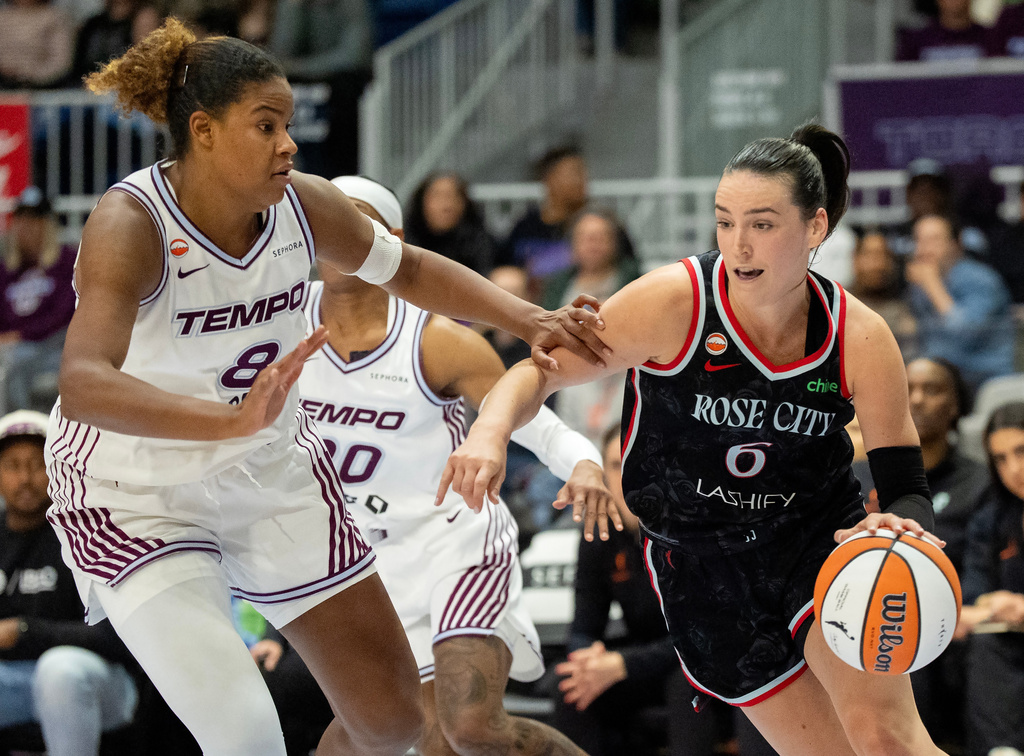 Portland Fire guard Bridget Carleton (6) drives against Toronto Tempo forward Nyara Sabally (8) during the first half of a WNBA basketball game in Toronto, Saturday May 23, 2026. (Frank Gunn/The Canadian Press via AP)