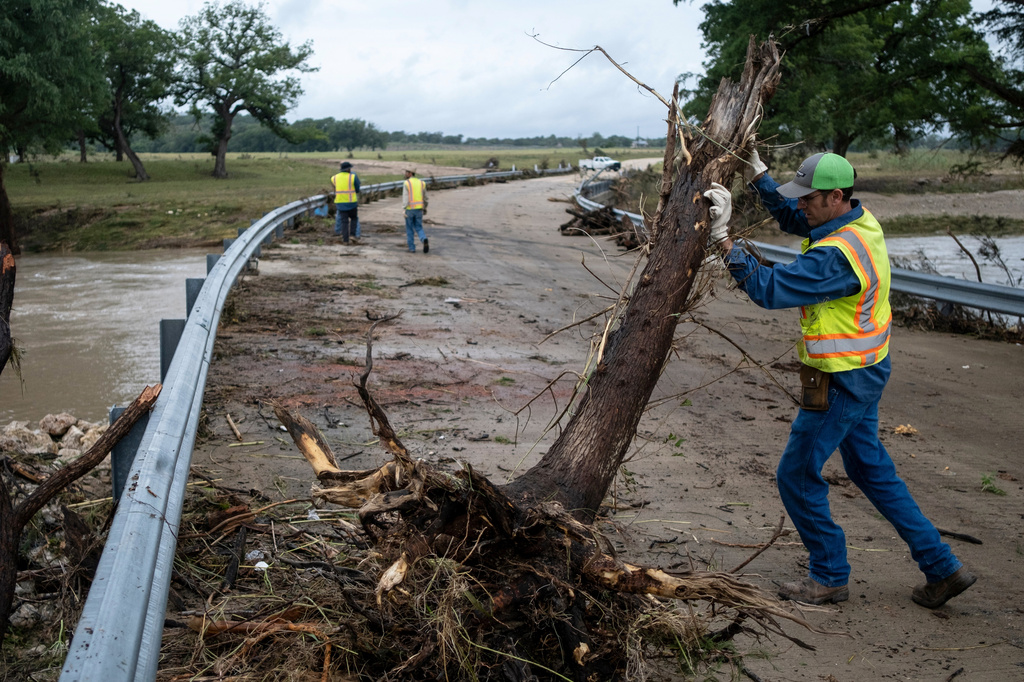 Crews clean up flood debris along the Guadalupe River on Friday, July 17, 2026, in Comfort, Texas. (AP Photo/Joel Angel Juarez)