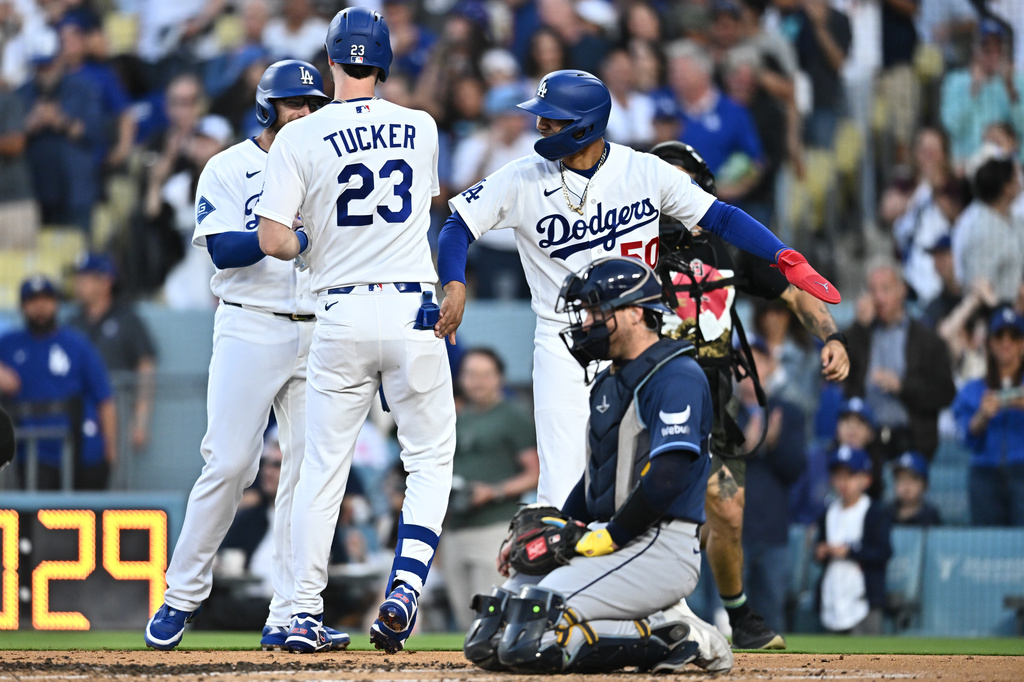 Los Angeles Dodgers' Kyle Tucker (23) is greeted by teammates after hitting a three-run home run during the second inning of a baseball game against the Tampa Bay Rays, Monday, June 15, 2026, in Los Angeles. (AP Photo/William Liang)
