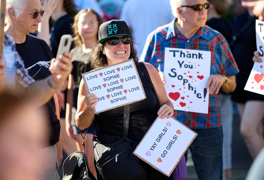 People rally to support Indiana Fever guard Sophie Cunningham after her comments on transgender athletes in women's sports before a WNBA basketball game between the Portland Fire and the Indiana Fever in Portland, Ore., Friday, July 31, 2026. (AP Photo/Craig Mitchelldyer)