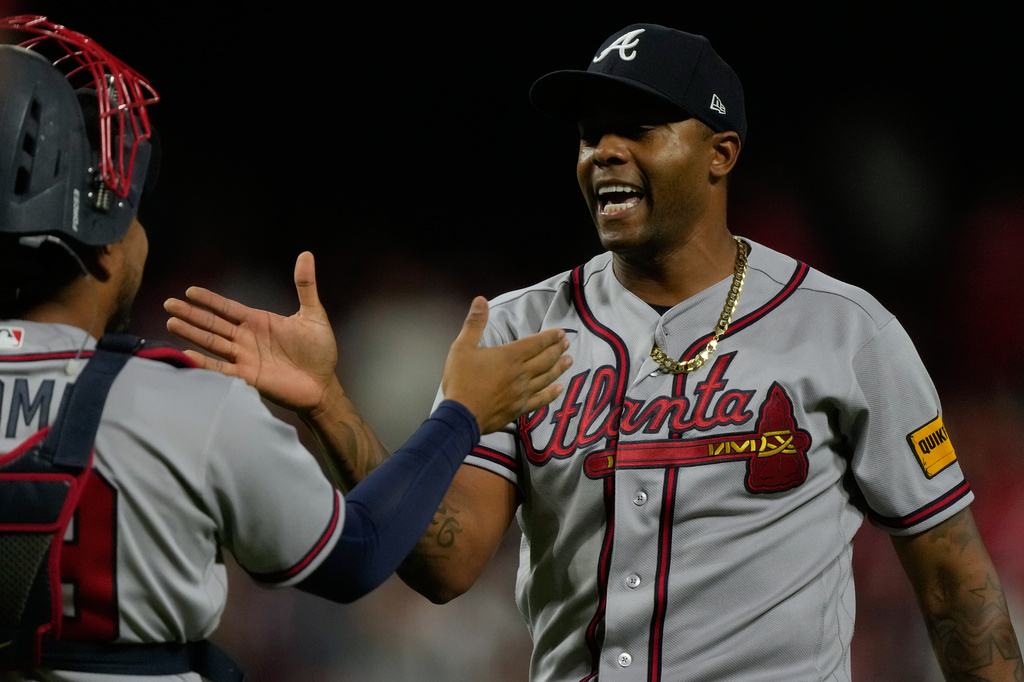 Atlanta Braves pitcher Raisel Iglesias, right, celebrates with catcher Chadwick Tromp after winning a baseball game against the Cincinnati Reds in Cincinnati, Saturday, May 30, 2026. (AP Photo/Carolyn Kaster)