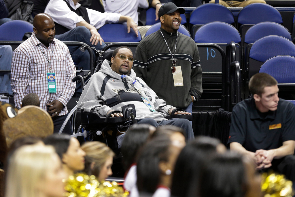 FILE - Former Wake Forest star and a 12-year NBA player Rodney Rogers, center, watches the first half of an NCAA college basketball game between Wake Forest and Maryland, in Greensboro, N.C., March 14, 2013. (AP Photo/Chuck Burton, File)
