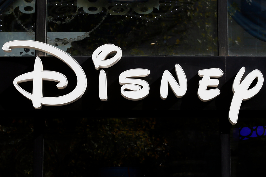FILE - The Disney logo is seen on their store along the Champs Elysees Avenue in Paris on Sept. 20, 2017. (AP Photo/Francois Mori, File)