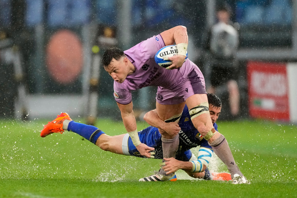 Scotland's Jack Dempsey, front, is tackled by Italy's Alessandro Fusco during the Six Nations rugby match between Italy and Scotland at Rome's Olympic Stadium, Saturday, Feb. 7, 2026. (AP Photo/Gregorio Borgia)