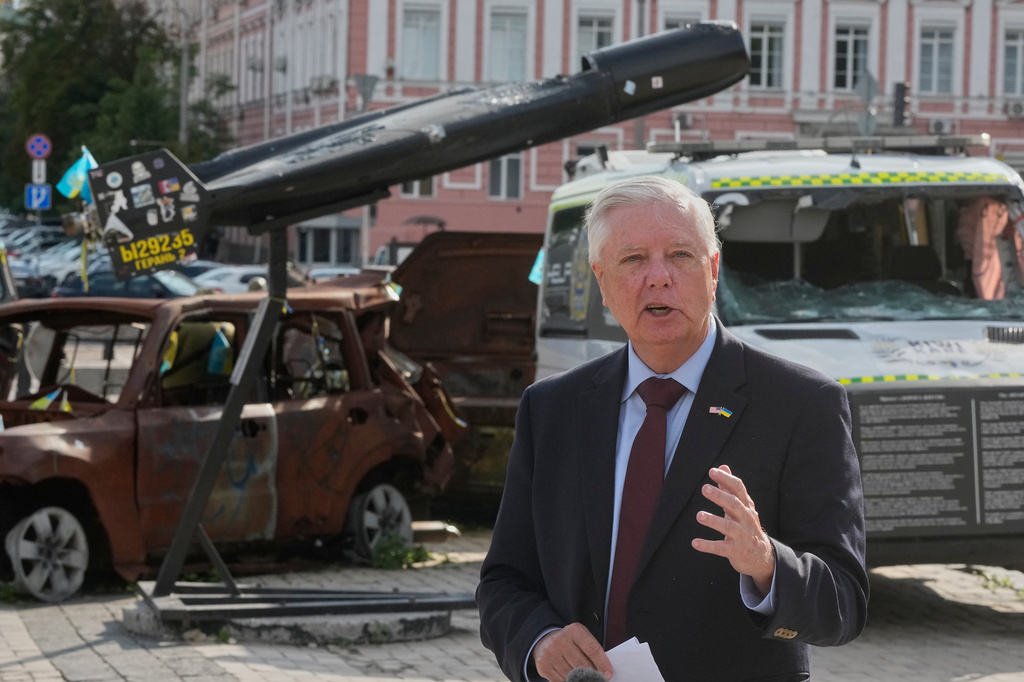 U.S. Sen. Lindsey Graham, R-S.C. answer media questions near damaged Russian vehicles exhibition in central Kyiv, Friday, July 10, 2026. (AP Photo/Efrem Lukatsky)