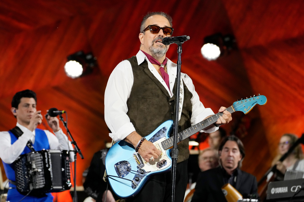 FILE - Frontman Raul Malo, center, and The Mavericks perform during the Boston Pops Fireworks Spectacular in Boston on July 4, 2024. (AP Photo/Michael Dwyer, File)
