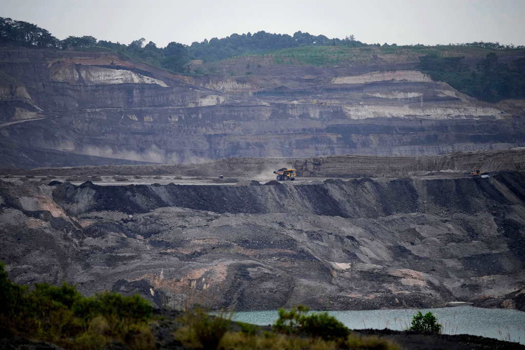 FILE - A dump truck carrying coal navigates its way near a coal mining pit in Sanga-Sanga, East Kalimantan, Indonesia, Dec. 20, 2022. (AP Photo/Dita Alangkara, File)