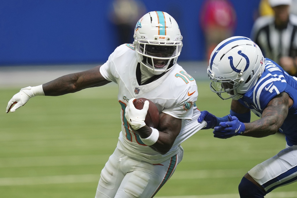 Miami Dolphins wide receiver Tyreek Hill (10) is tackled by Indianapolis Colts cornerback Charvarius Ward (7) during the second half of an NFL football game Sunday, Sept. 7, 2025, in Indianapolis. (AP Photo/Darron Cummings)