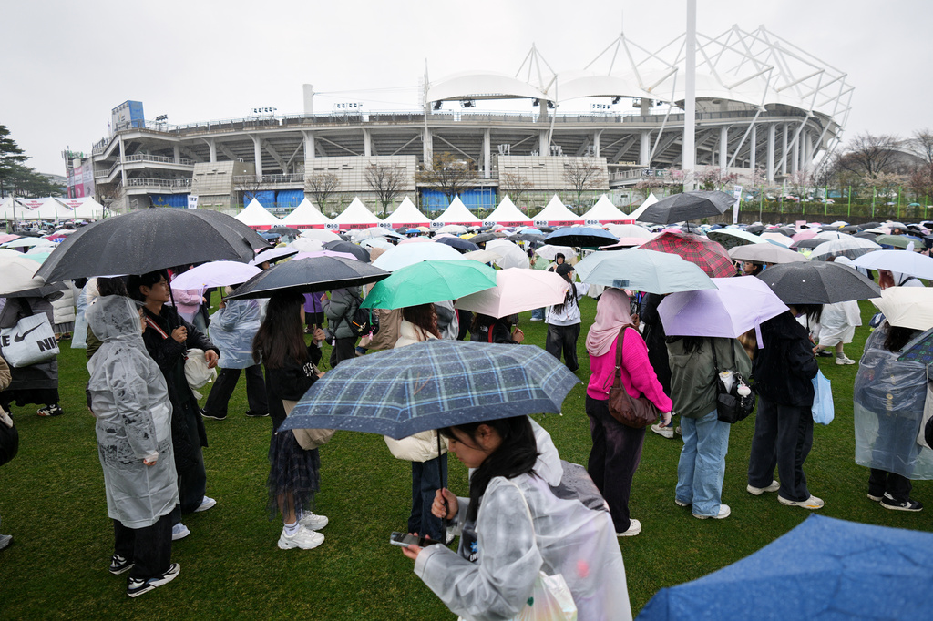 Fans of K-pop band BTS stand in lines at a fan zone for the BTS World Tour Arirang in Goyang, South Korea, Thursday, April 9, 2026. (AP Photo/Lee Jin-man)