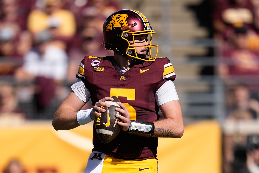 Minnesota quarterback Drake Lindsey (5) looks to pass during the first half of an NCAA college football game against Rutgers, Saturday, Sept. 27, 2025, in Minneapolis. (AP Photo/Abbie Parr)