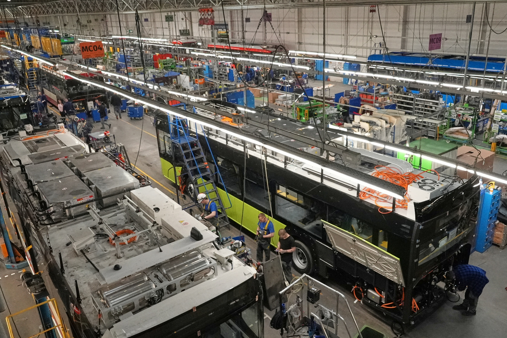 Workers build electric buses at the Solaris bus factory in Poznan, Poland, Thursday, Jan. 29, 2026. (AP Photo/Pietro De Cristofaro)