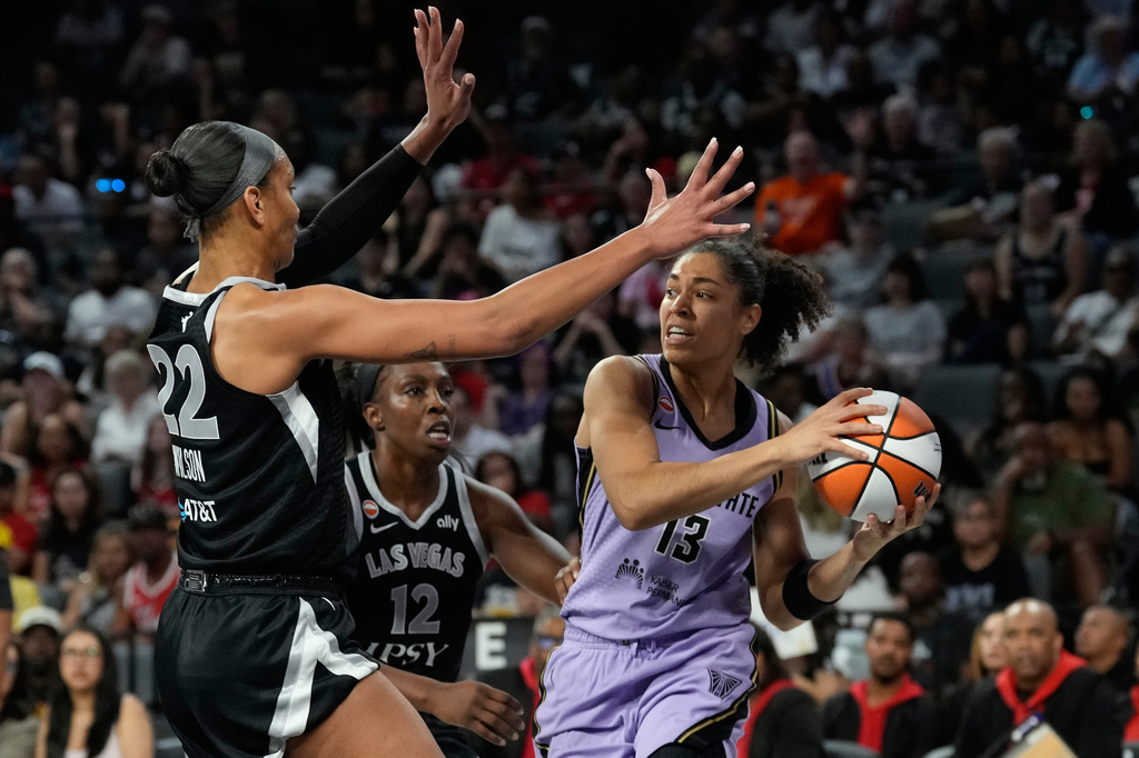 Golden State Valkyries forward Janelle Salaun (13) passes around Las Vegas Aces center A'ja Wilson (22) and Las Vegas Aces guard Chelsea Gray (12) during the first half of a WNBA basketball game Sunday, June 21, 2026, in Las Vegas. (AP Photo/John Locher)