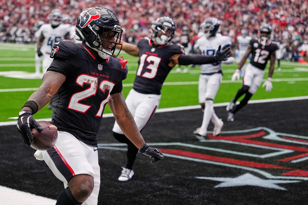 Houston Texans running back Woody Marks (27) celebrates his touchdown during the second half of an NFL football game against the Tennessee Titans, Sunday, Sept. 28, 2025, in Houston. (AP Photo/David J. Phillip)