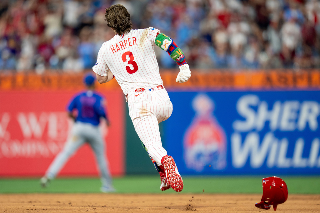 Philadelphia Phillies' Bryce Harper runs the bases on his way to a triple for the cycle during the fifth inning of a baseball game against the New York Mets, Saturday, June 20, 2026, in Philadelphia. (AP Photo/Chris Szagola)