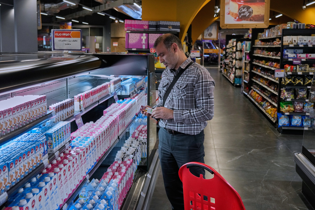 FILE - A customer shops at a supermarket at a shopping mall in northern Tehran, on Sept. 28, 2025. (AP Photo/Vahid Salemi, File)