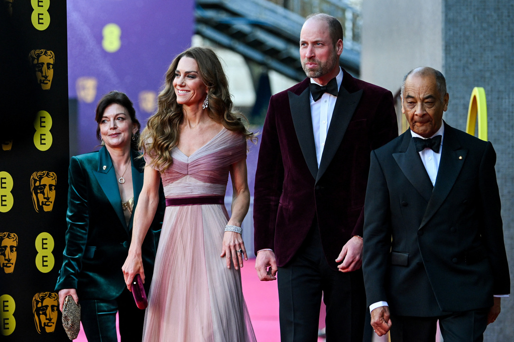 Britain's Prince William and Kate, Princess of Wales arrive with Jane Millichip, CEO of the British Academy of Film and Television Arts and Lord-Lieutenant of Greater London Ken Olisa to the 79th British Academy Film Awards, at the Royal Festival Hall, in London, Sunday Feb. 22, 2026. (Jaimi Joy/Pool Photo via AP)