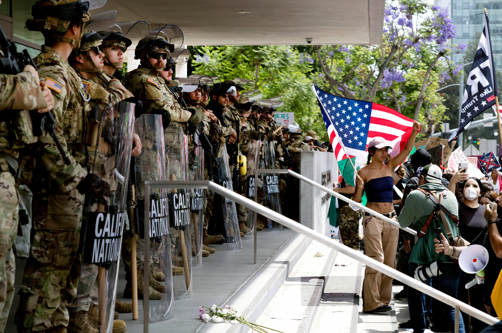 FILE - Protesters stand off against California National Guard soldiers at the Federal Building in downtown Los Angeles, during a "No Kings" protest, June 14, 2025. (AP Photo/Richard Vogel, File)