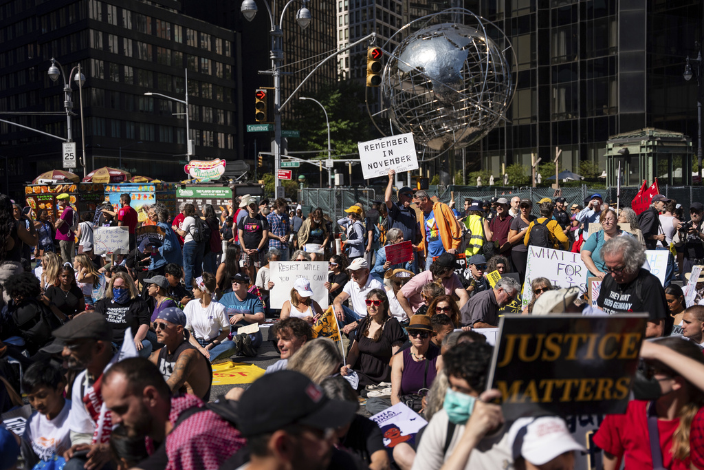 Protestors sit for a moment of silence for the Global South at the "Make Billionaires Pay" climate protest, Saturday, Sept. 20, 2025, in New York. (AP Photo/Angelina Katsanis)