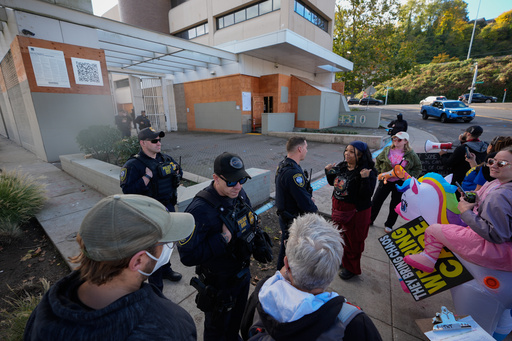 Law enforcement officers talk with protesters outside a United States Immigration and Customs Enforcement (ICE) facility in Portland, Ore., Monday, Oct. 20, 2025. (AP Photo/Jenny Kane) Law enforcement officers talk with protesters outside a United States Immigration and Customs Enforcement (ICE) facility in Portland, Ore., Monday, Oct. 20, 2025. (AP Photo/Jenny Kane)