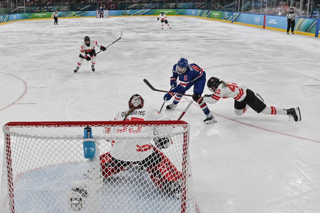 United States' Megan Keller (5) scores the winning goal during the women's ice hockey gold medal game between the United States and Canada at the 2026 Winter Olympics, in Milan, Italy, Thursday, Feb. 19, 2026. (Alexander Nemenov/Pool Photo via AP)