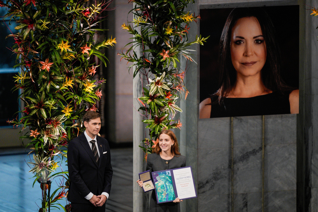 The daughter of the Nobel Peace Prize laureate, Ana Corina Sosa, accepts the award on behalf of her mother, Venezuelan opposition leader Maria Corina Machado, during the Nobel Peace Prize ceremony at Oslo City Hall, Norway, Wednesday Dec. 10, 2025. (Stian Lysberg Solum/NTB Scanpix via AP)