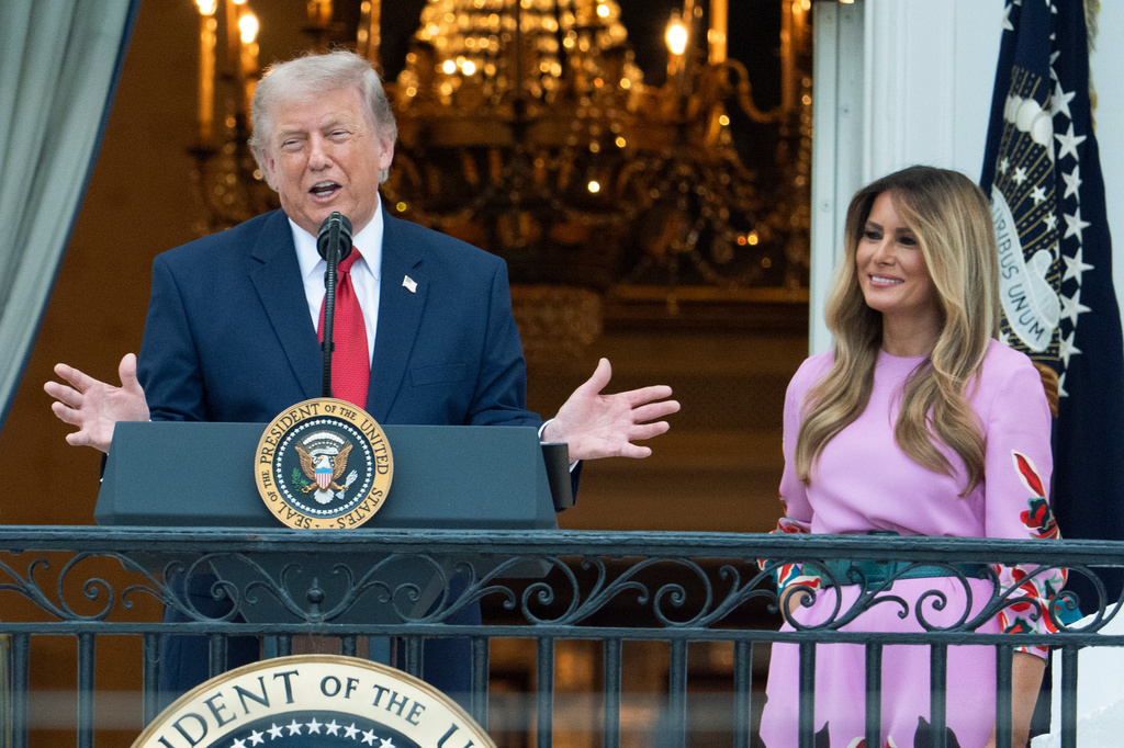 President Donald Trump with first lady Melania Trump addresses the attendees from the Blue Room Balcony of the White House during the annual Congressional Picnic on the South Lawn, Tuesday, May 19, 2026, in Washington. (AP Photo/Manuel Balce Ceneta)