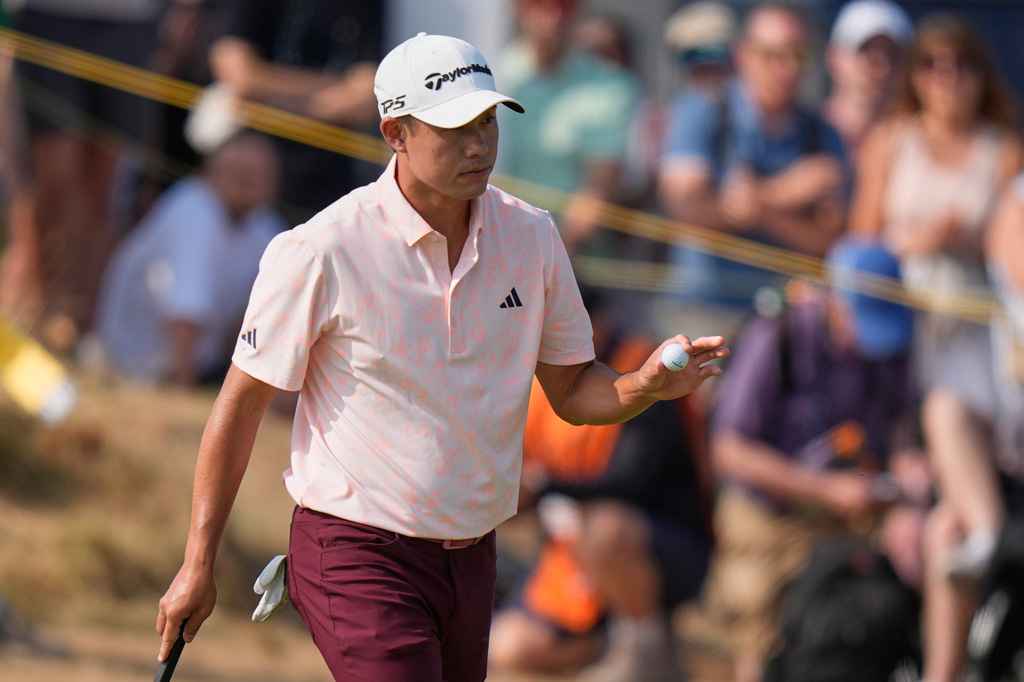Collin Morikawa of the United States acknowledges the crown on the 1st green after putting during the second day of the British Open Golf championships at Royal Birkdale golf club, in Southport, England, Friday, July 17, 2026. (AP Photo/David Goldman)