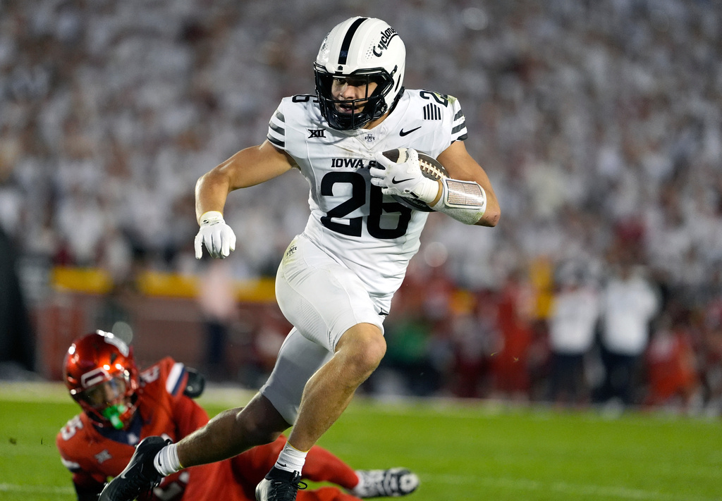 Iowa State running back Carson Hansen (26) eludes a tackle by Arizona defense as he runs in a touchdown during the first half of an NCAA college football game, Saturday, Sept. 27, 2025, in Ames, Iowa. (AP Photo/Matthew Putney)