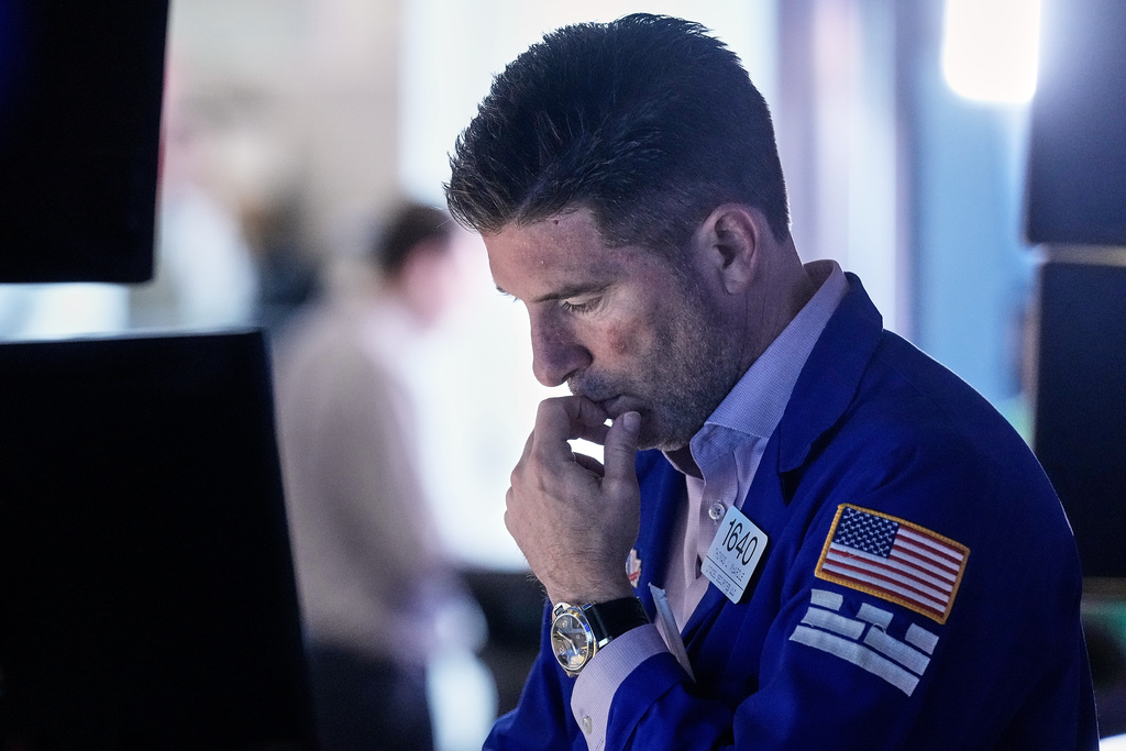 Specialist Thomas McArdle works at his post on the floor of the New York Stock Exchange, Friday, Feb. 20, 2026. (AP Photo/Richard Drew)