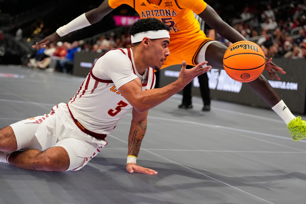Iowa State's Tamin Lipsey (3) tries to pass around Arizona State's Massamba Diop during the second half of an NCAA college basketball game in the second round of the Big 12 Conference tournament Wednesday, March 11, 2026, in Kansas City, Mo. (AP Photo/Charlie Riedel)