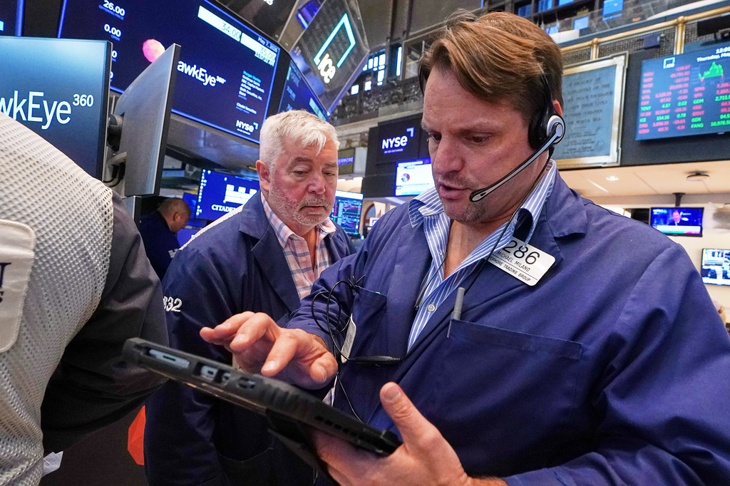 Trader Edward McCarthy, left, and Michael Milano work on the floor of the New York Stock Exchange, Thursday, May 7, 2026. (AP Photo/Richard Drew)