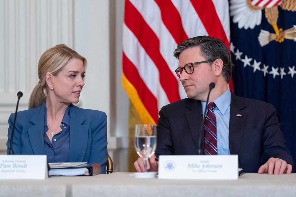 Attorney General Pam Bondi, left, and House Speaker Mike Johnson of La., talk before President Donald Trump arrives for a board meeting of the John F. Kennedy Memorial Center For The Performing Arts in the East Room of the White House, Monday, March 16, 2026, in Washington. (AP Photo/Alex Brandon)