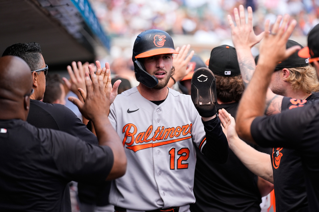 Baltimore Orioles' Dylan Beavers (12) celebrates scoring against the Detroit Tigers during the eighth inning of a baseball game Wednesday, July 29, 2026, in Detroit. (AP Photo/Paul Sancya)