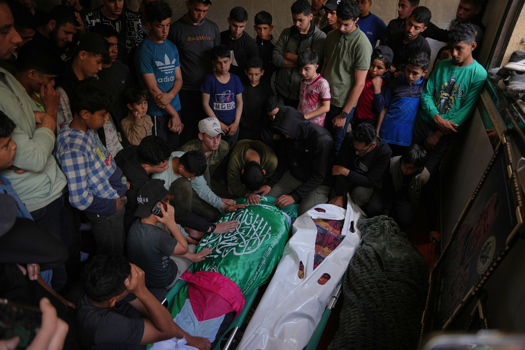 Palestinians mourn over the bodies of Izz al-Din al-Haddad, the leader of Hamas' Qassam Brigades, left, his daughter, center and wife during their funeral in Gaza City, Saturday, May 16, 2026. (AP Photo/Abdel Kareem Hana)