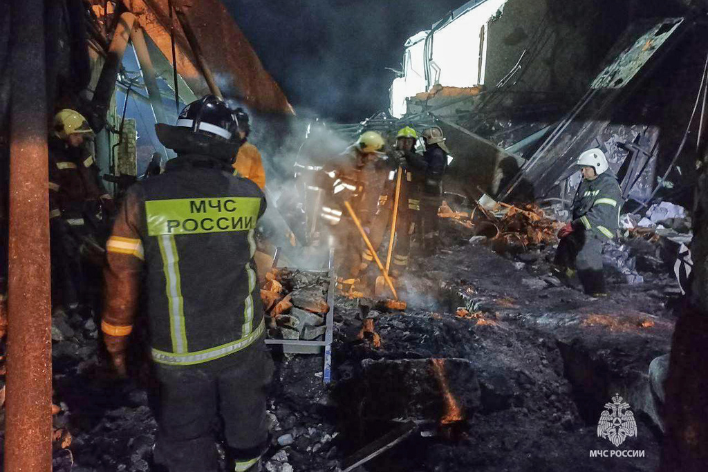 In this photo, released by the Russian Emergency Ministry Press Service on Saturday, Aug. 16, 2025, Emergency Ministry employees work in debris of an industrial plant after a fire at the facility in the Shilovsky District, Ryazan region, around 250 kilometers (155 miles) southeast of Moscow, Russia. (Russian Emergency Ministry Press Service via AP)