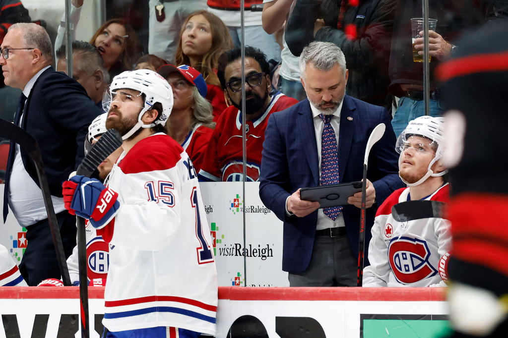Montreal Canadiens head coach Martin St Louis, center right, looks to challenge a goal by the Carolina Hurricanes during the first period in Game 5 of the Eastern Conference finals NHL hockey Stanley Cup playoff series in Raleigh, N.C., Friday, May 29, 2026. (AP Photo/Karl DeBlaker)