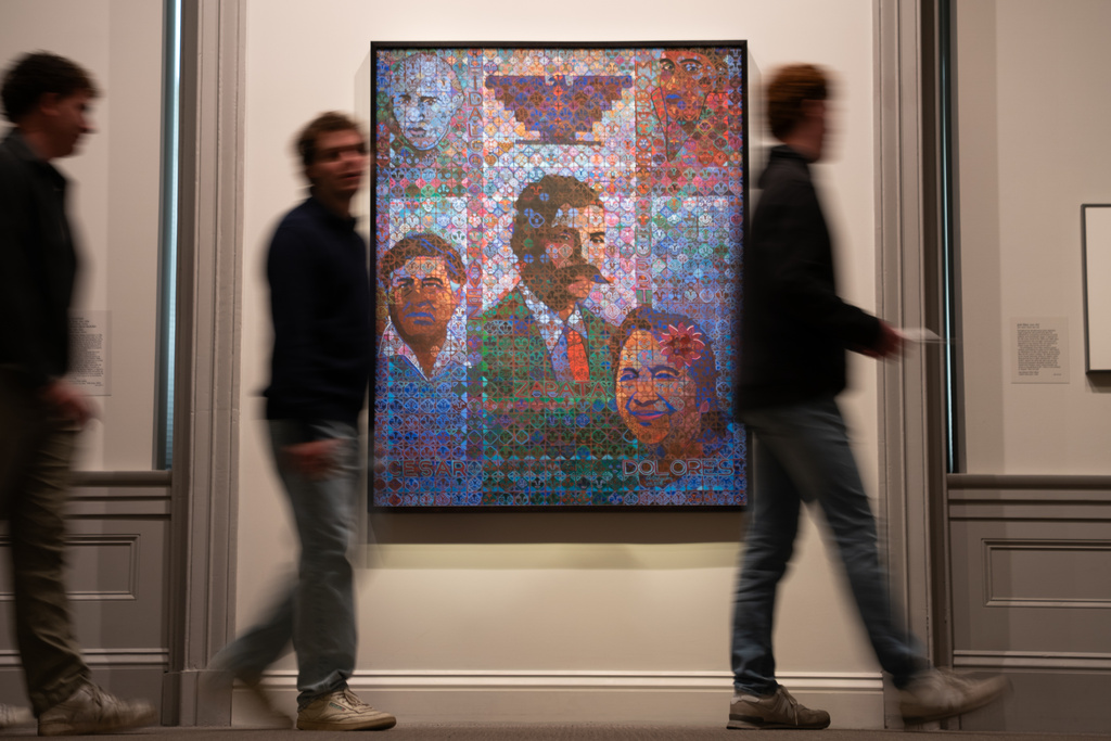 Museum attendees walk past a painting of individuals including César Chavez at the National Portrait Gallery on Thursday, March 19, 2026, in Washington. (AP Photo/Allison Robbert)