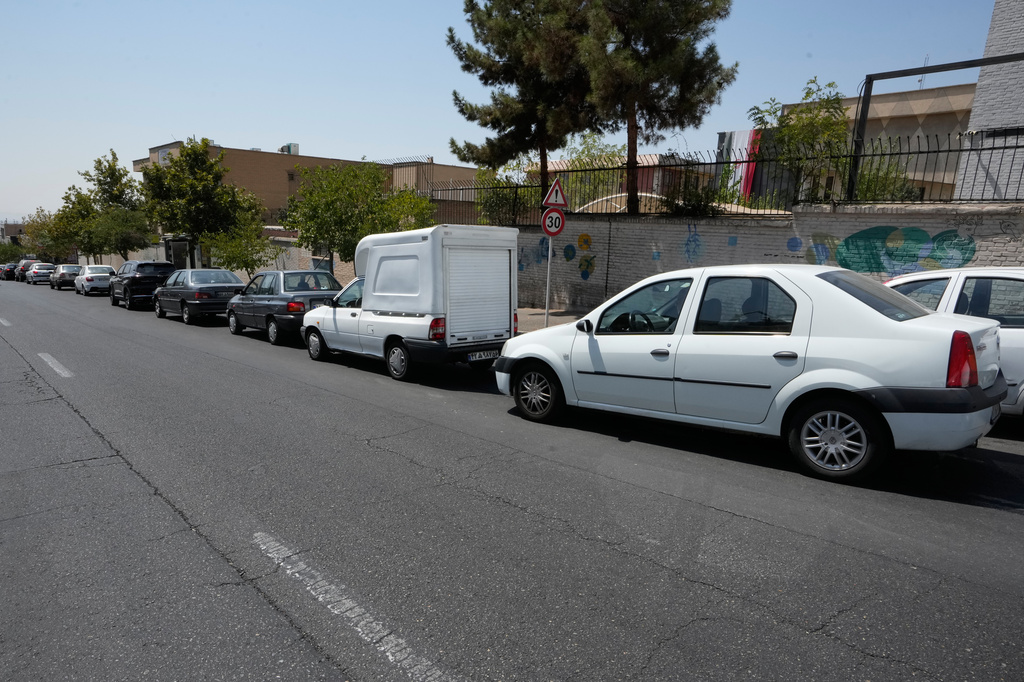 Cars line up outside a gas station in Tehran, Iran, Tuesday, Aug. 25, 2026. (AP Photo/Vahid Salemi)