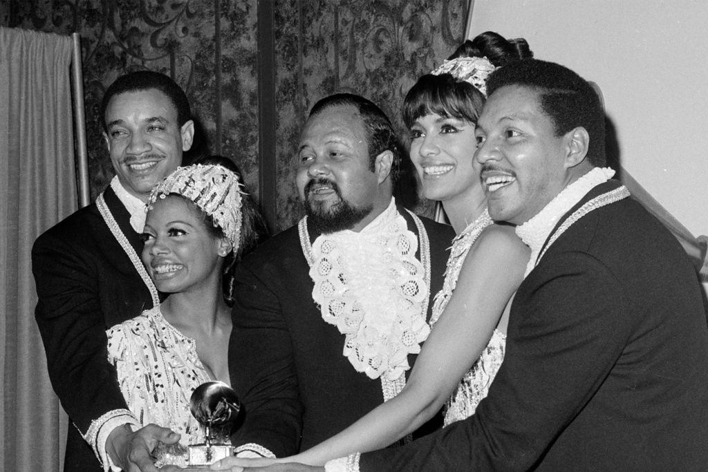 FILE - Members of the Fifth Dimension, from left, LaMonte McLemore, Florence LaRue, Ron Townson, Marilyn McCoo, and Billy Davis, Jr., pose with their Grammy Award in Los Angeles on Feb. 29, 1968. (AP Photo/Harold P. Matosian, File)