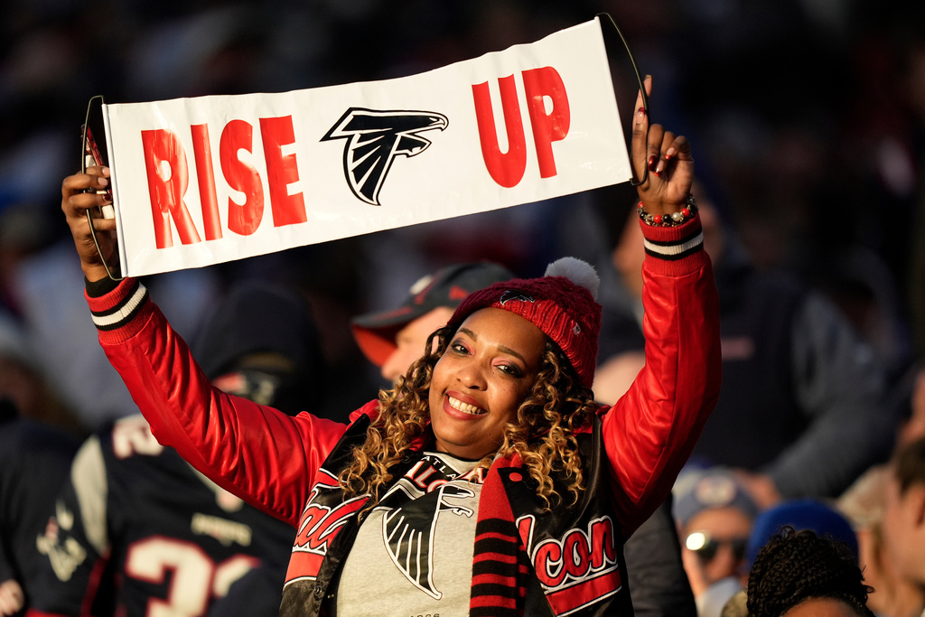 A Atlanta Falcons fan cheers during the second half of an NFL football game against the Atlanta Falcons, Sunday, Nov. 2, 2025, in Foxborough, Mass. (AP Photo/Robert F. Bukaty)