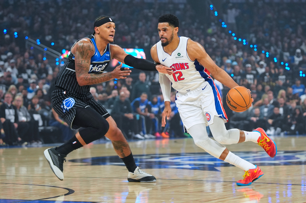Detroit Pistons forward Tobias Harris (12) drives against Orlando Magic forward Paolo Banchero (5) during the first half in Game 6 of a first-round NBA basketball playoffs series, Friday, May 1, 2026, in Orlando, Fla. (AP Photo/John Raoux)