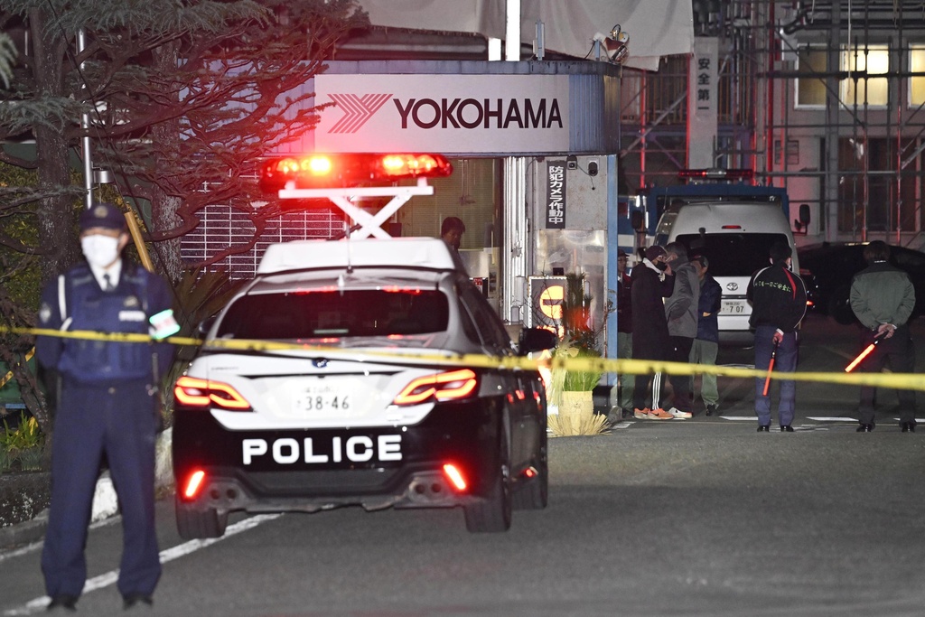Police officers stand guard at the scene of a stabbing at the Yokohama Rubber Company in Mishima, west of Tokyo, Friday, Dec. 26, 2025. (Yusuke Hashizume/Kyodo News via AP)