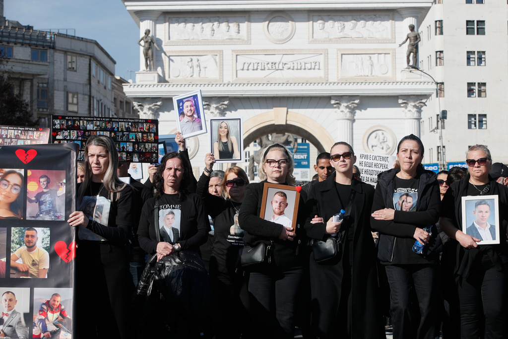 Relatives carry pictures of the Kocani nightclub fire victims, a fire that killed 63 people, during a protest in Skopje, North Macedonia, on Saturday, Nov. 15, 2025, just a few days before the start of the trial for the fire. (AP Photo/Boris Grdanoski)